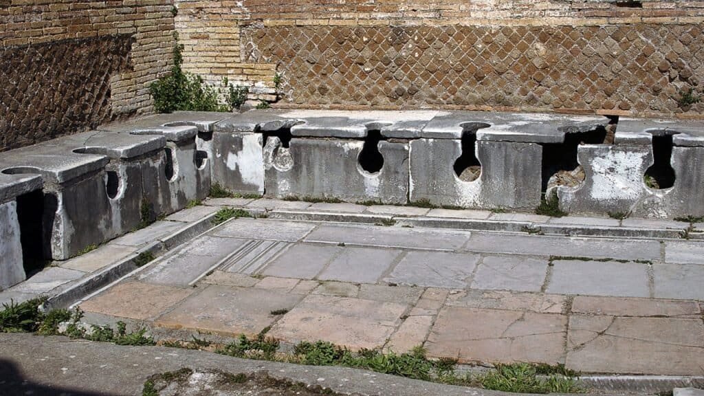 Ancient Roman Empire public toilet highlighting early communal sanitation in the history of the bathroom.